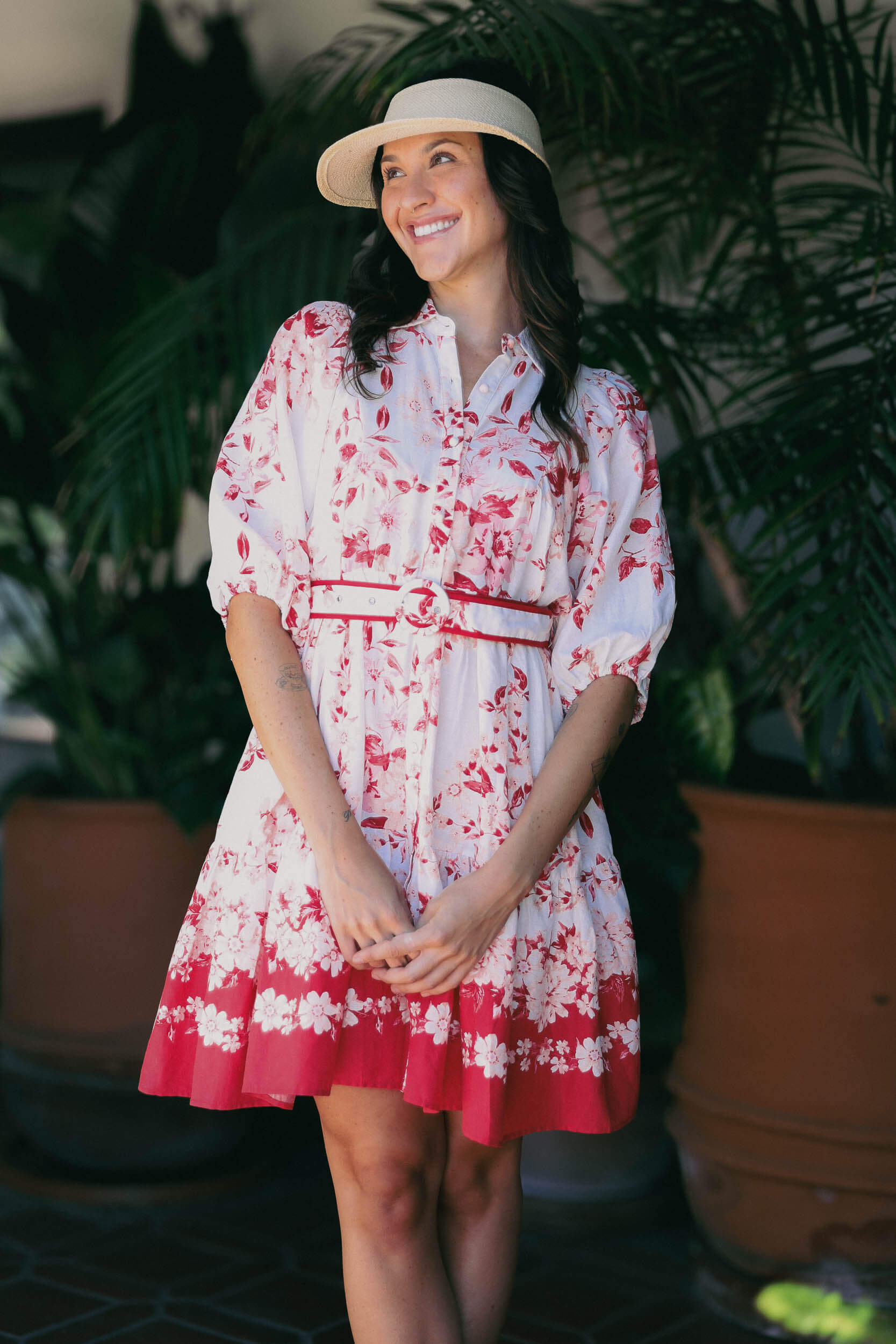 Womens white dress with red and pink floral print throughout and waist belt