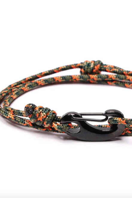 Bracelet with camouflage pattern and black clasp on a white background