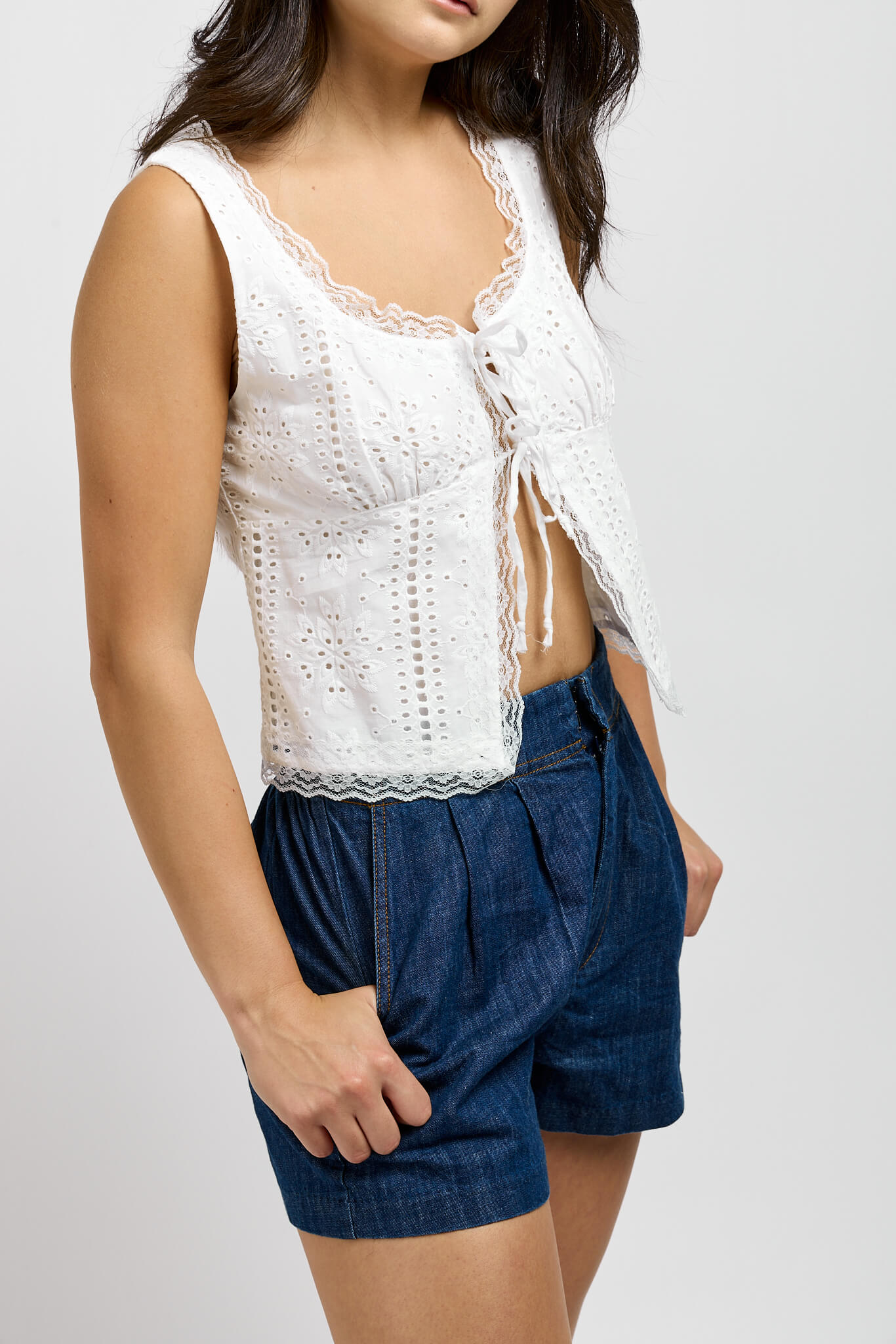 Womens white sleeveless open top with front ties and eyelet detailing