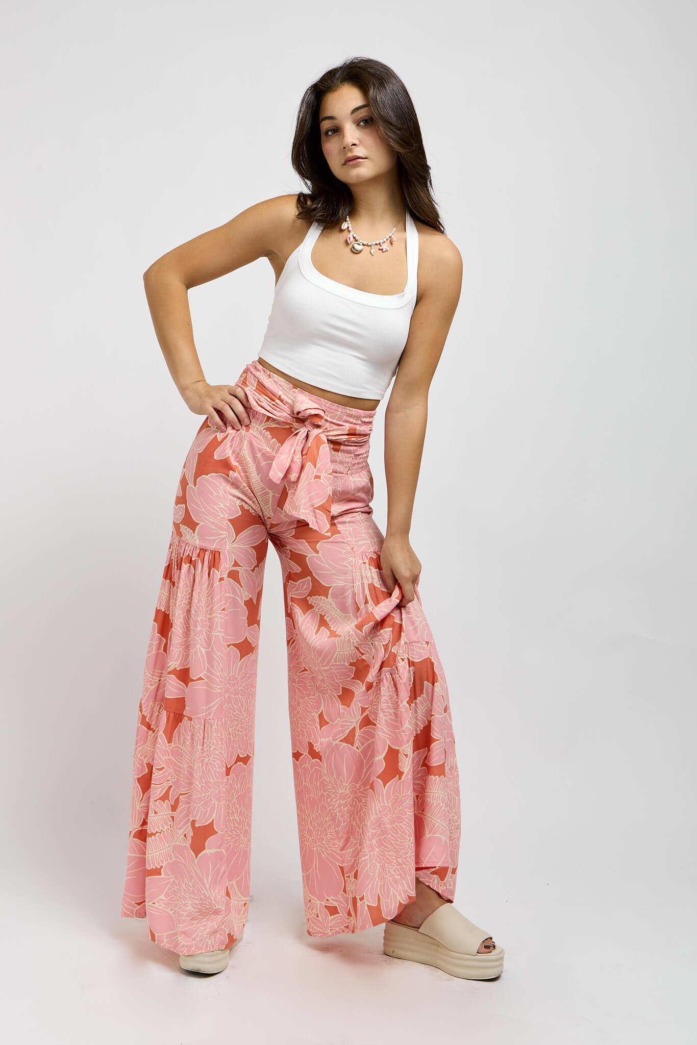 Womens orange pants with pink floral print throughout