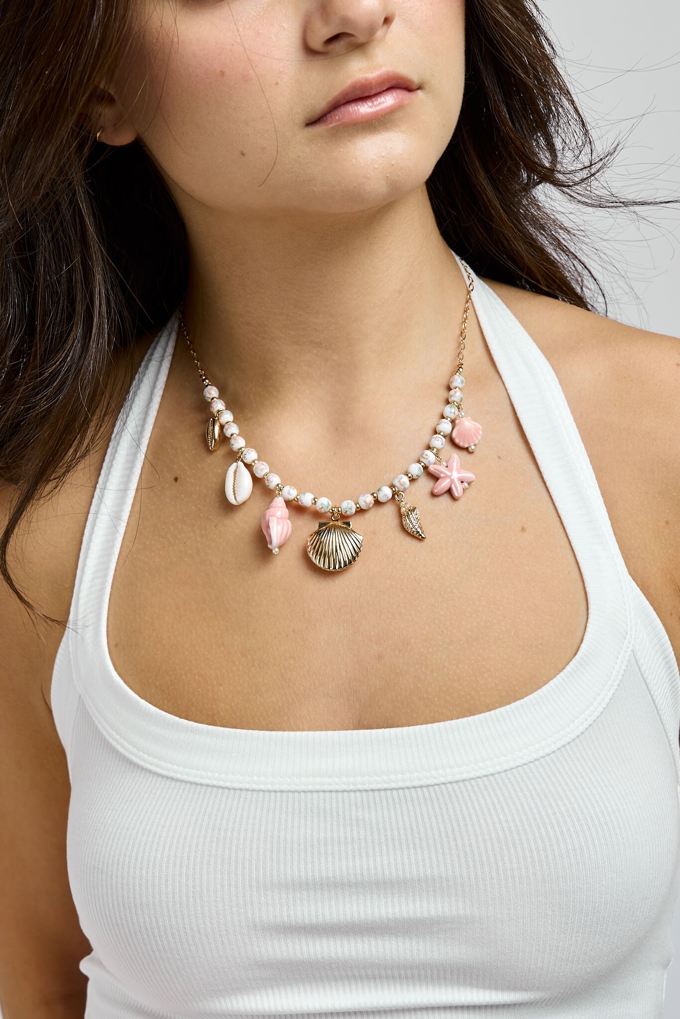 Womens gold, white, and pink necklace