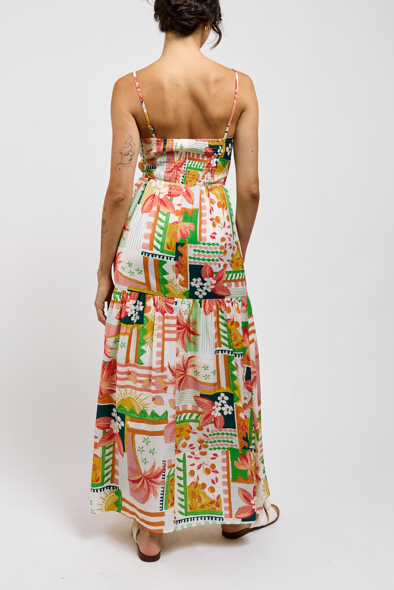 Womens maxi dress with stretchy back and adjustable spaghetti straps. Dress is white with tropical toned print throughout