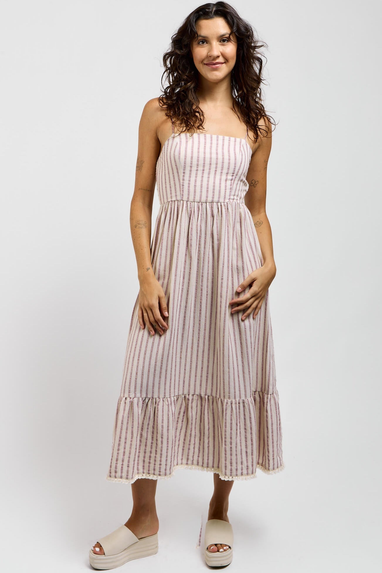 Womens vertical striped dress with a straight neckline and ruffled bottom