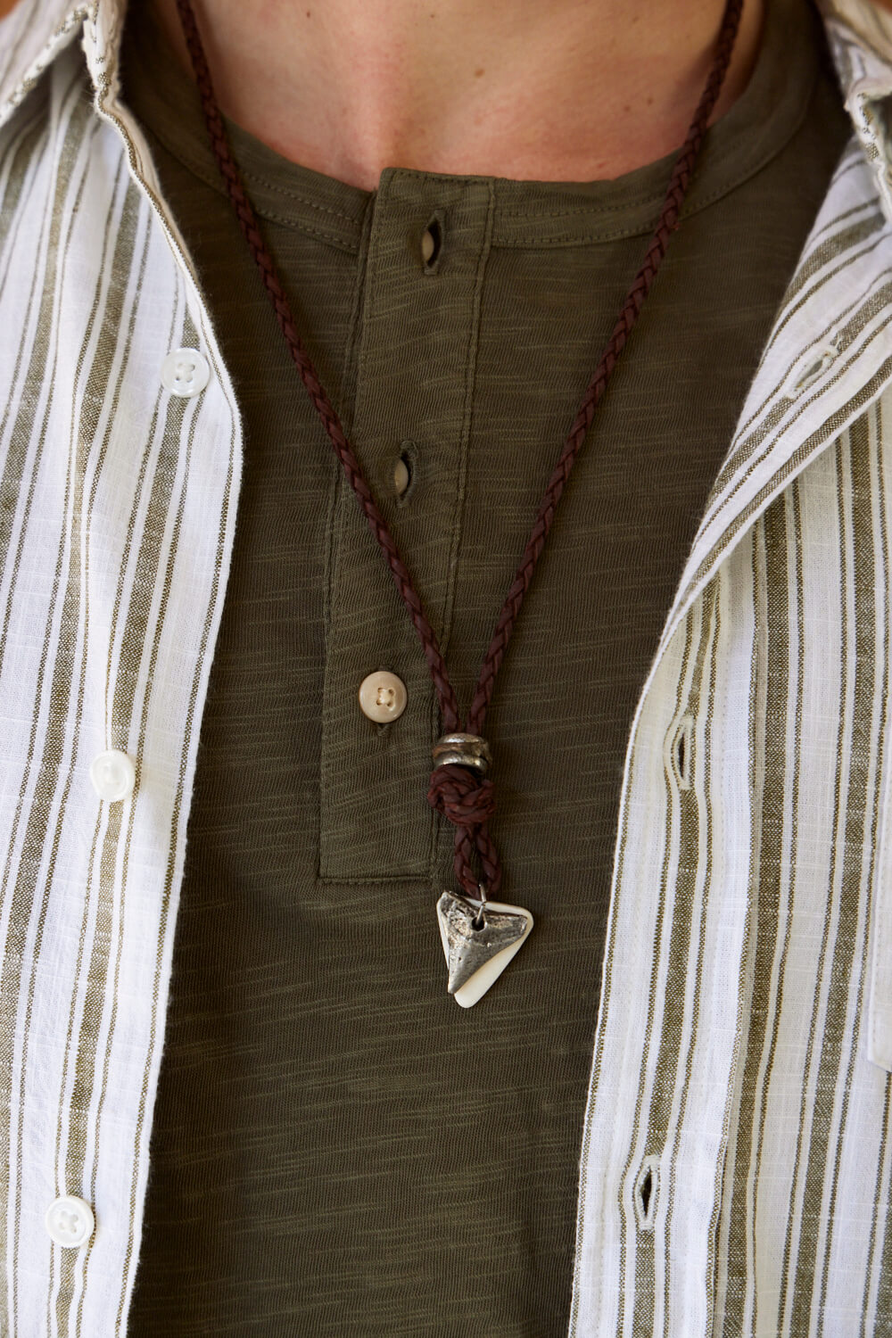 Anju Jewelry Aadi Shark Tooth Leather Necklace. Shop men’s jewelry for everyday wear. Men’s leather jewelry. Casual men’s jewelry. Popular men’s jewelry styles for casual outfits. Adventurous jewelry for men. Indian jewelry for men. Handmade jewelry for men of all styles. Feel the spirit of India when you wear Anju’s jewelry for men. Genuine leather necklaces and handwoven leather bracelets include metal accents and wooden accents. Easy men’s jewelry with an Indian flair will keep you looking stylish.