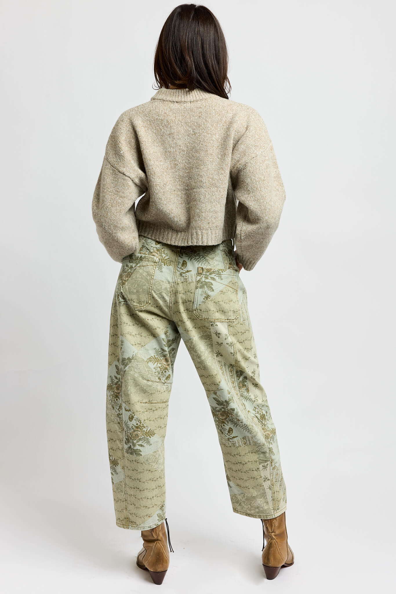 Womens printed jeans with green and brown hues that are equipped with back pockets