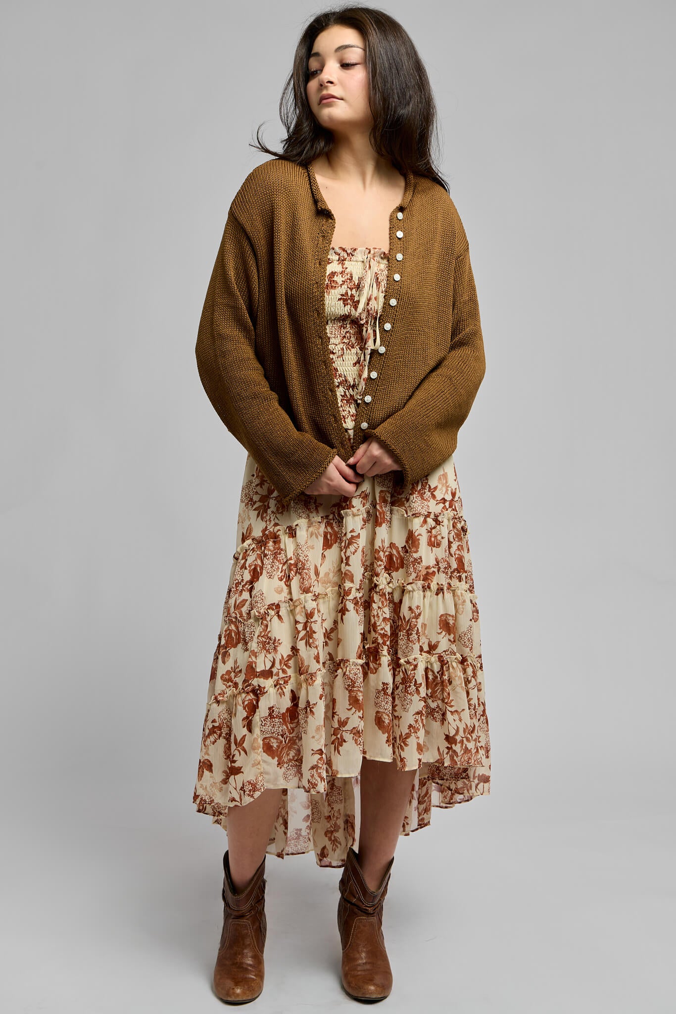 Womens printed maxi dress paired with a brown knit cardigan