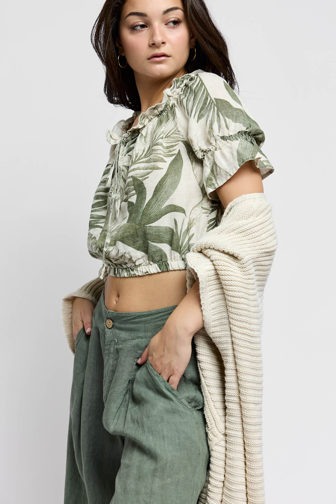 Womens crop top with green leaf print throughout and slight puff sleeves.