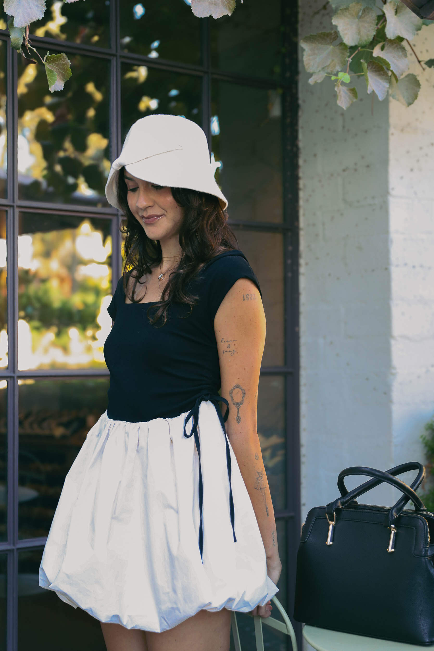 Womens cream colored hat with line details and bow detail