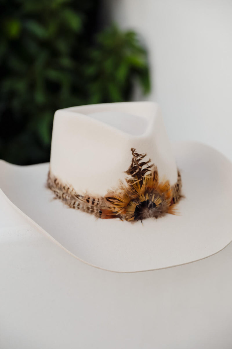 feathered brimmed hat