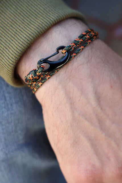Bracelet with anchor design on a wrist, blurred background