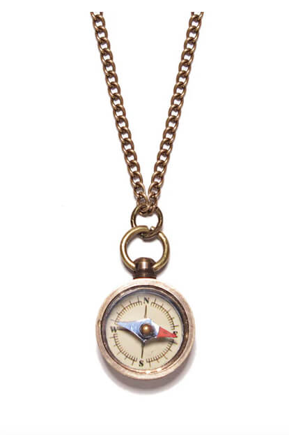 Compass necklace on a white background