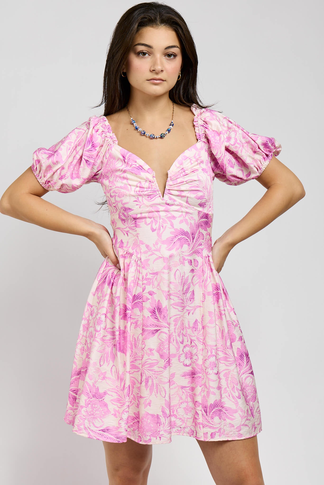Womens pink andcream colored dress with a sweetheart neckline and soft puff sleeves