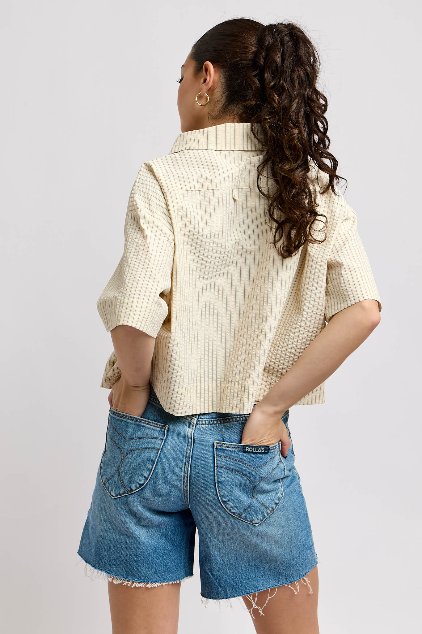 Womens cream colored shirt with brown vertical stripes throughout