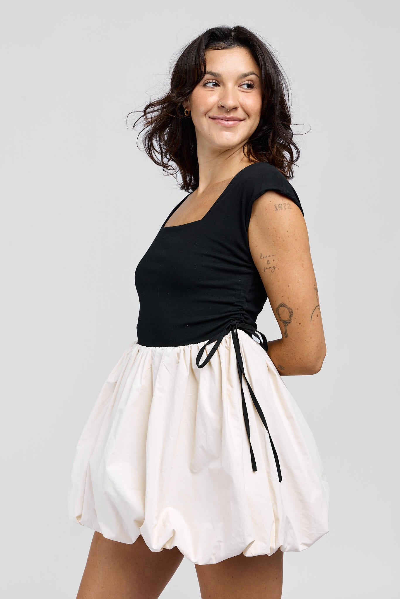 Womens mini dress with black bodice and cream colored bubble skirt