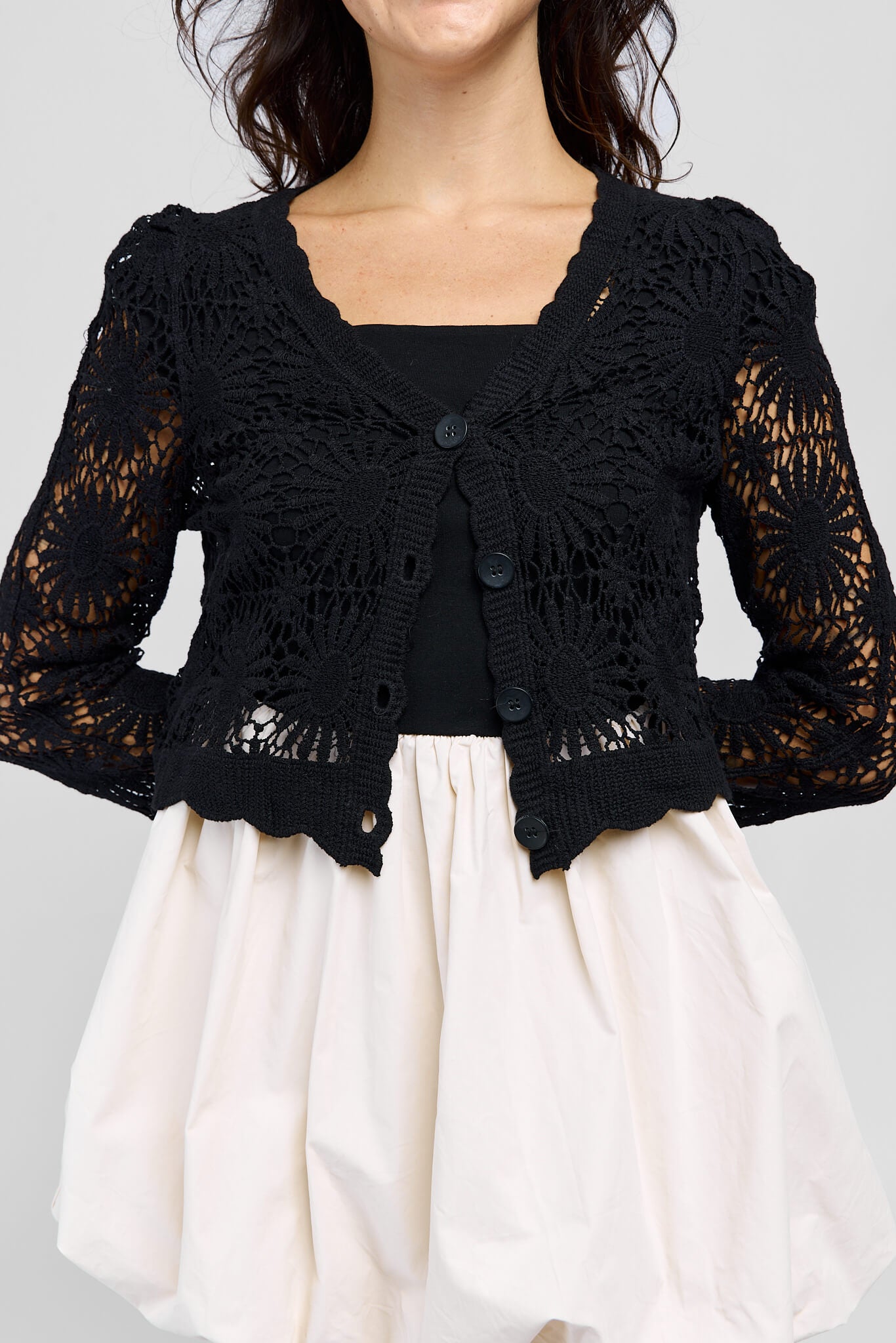 Womens black crocheted cardigan with buttons along front for optional closure