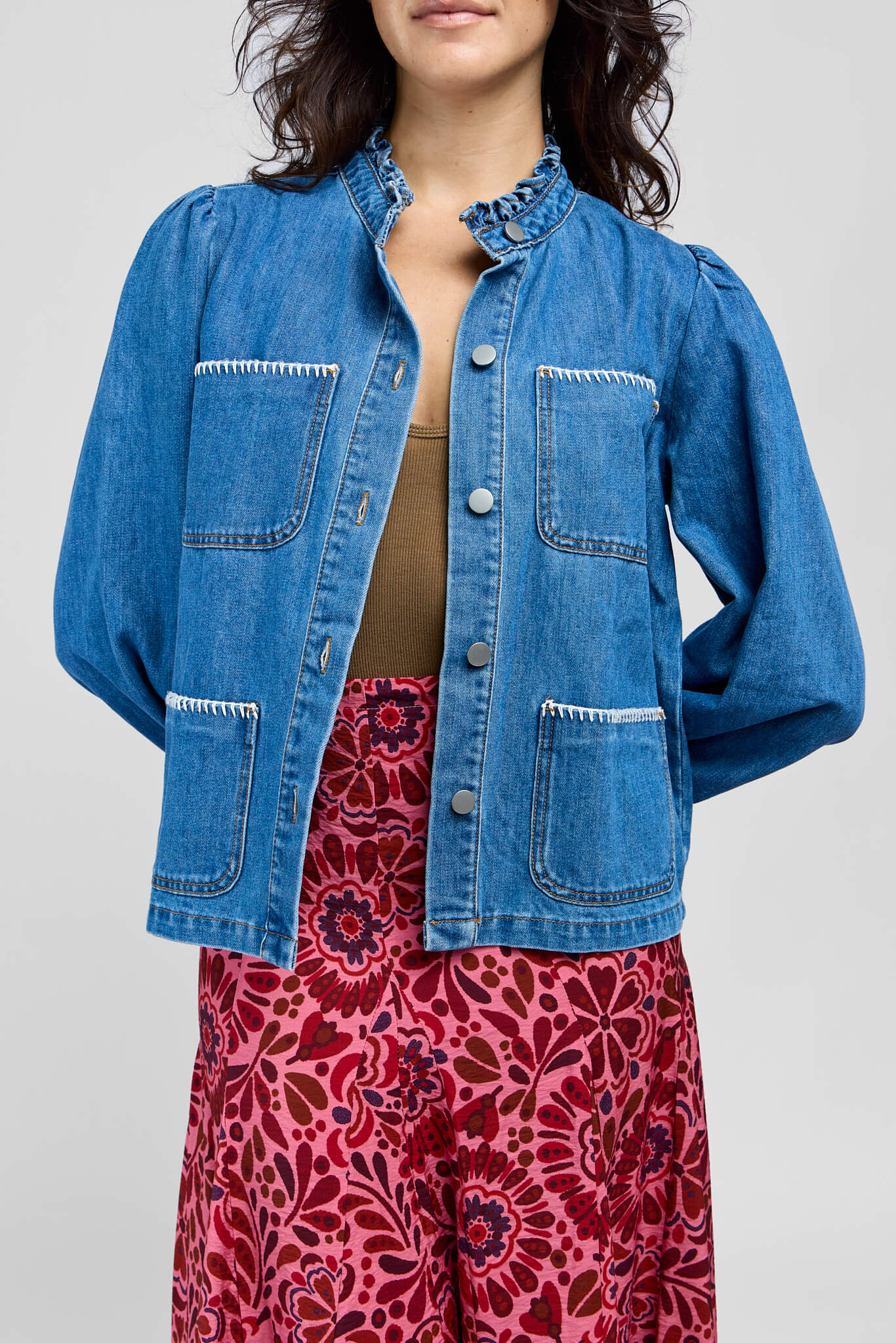 Womens blue denim jacket with white hem details throughout