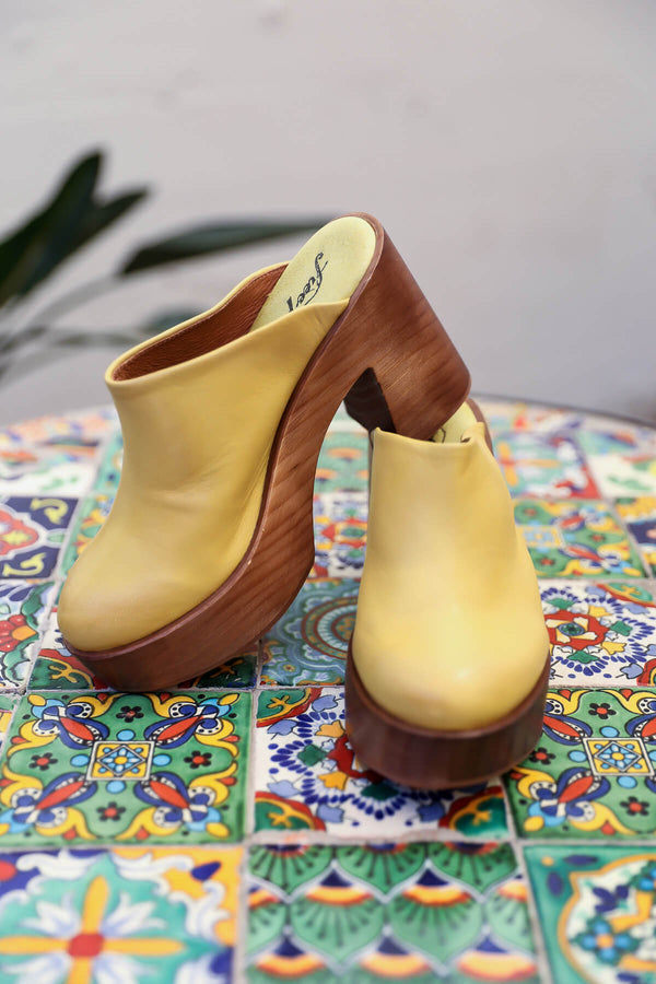 Women's marigold yellow wood clogs by Free People | Kariella